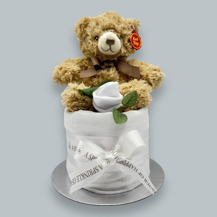 Bramble Bear plush toy atop nappy cake