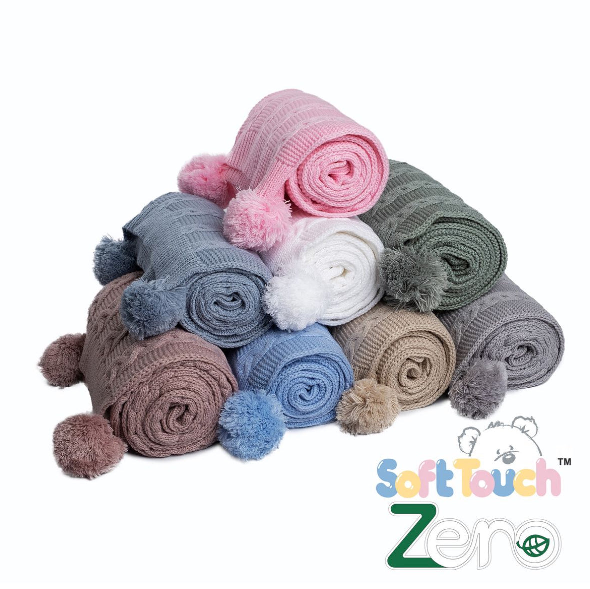 The full range of colours of the cable knit baby wrap with pom poms by Soft Touch Babywear, made from recycled yarn