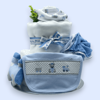 2-Tier Blue “Train” Nappy Cake with soft toy elephant and washcloth flower