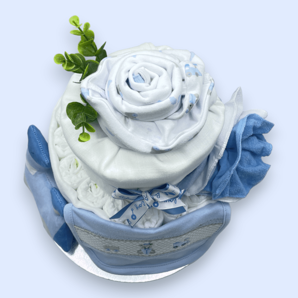 Hat and babygrow transformed into flower arrangement on 2-Tier Blue “Train” Nappy Cake