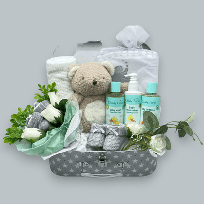 Childs Farm Baby Gift Set including a blanket, hooded towel, washcloths, socks, and a soft toy