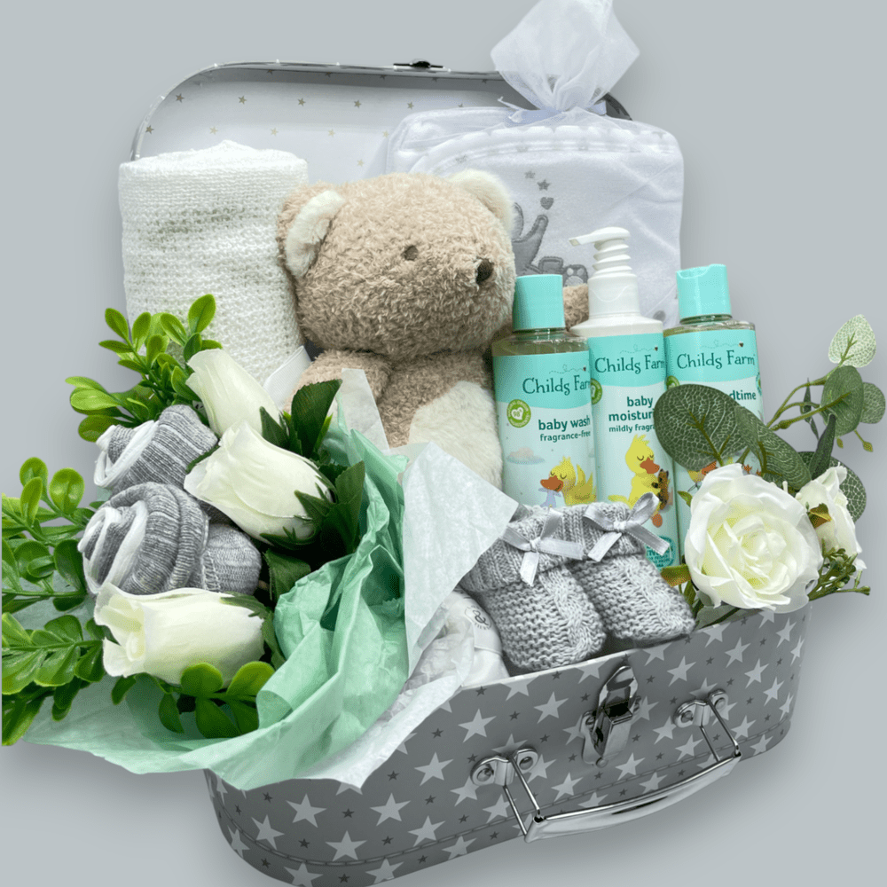 White and grey socks creatively turned into roses in the Childs Farm Baby Gift Set