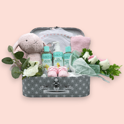 Childs Farm Baby Gift Set arranged in a stylish suitcase, ready for gifting