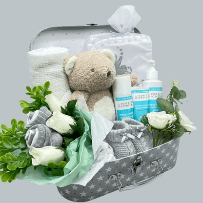 Bouquet with white roses, eucalyptus and White and grey socks styled as rosebuds in the gift set