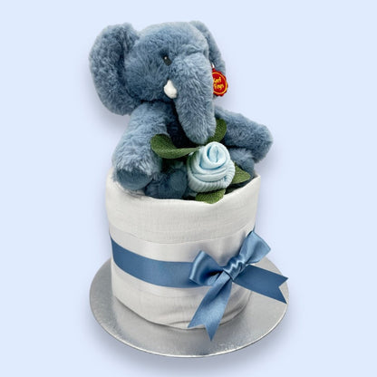 Ezra the Elephant plush toy perched on top of the Elephant Elegance Mini Nappy Cake