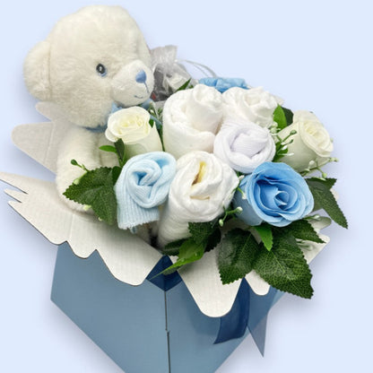 Side view of blue Baby Blossom gift box with Keeleco teddy, baby essentials and floral arrangement