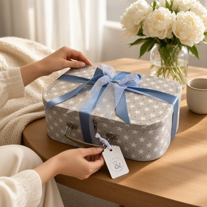 Blue new baby gift suitcase finished with coordinating ribbon