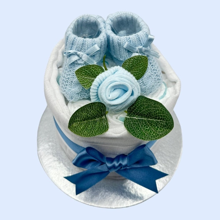 Tiny baby boy gift: mini nappy cake with blue accents, booties, and muslin