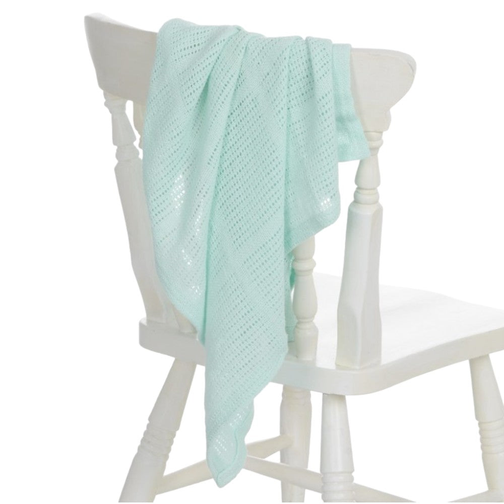 Mint cellular baby blanket styled as a new baby gift
