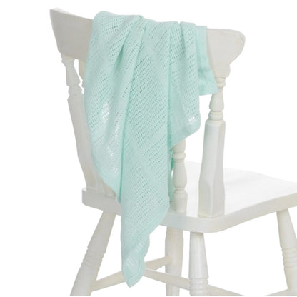 Mint cellular baby blanket styled as a new baby gift