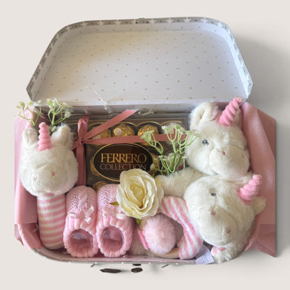 Pink new baby gift suitcase filled with thoughtful baby gifts